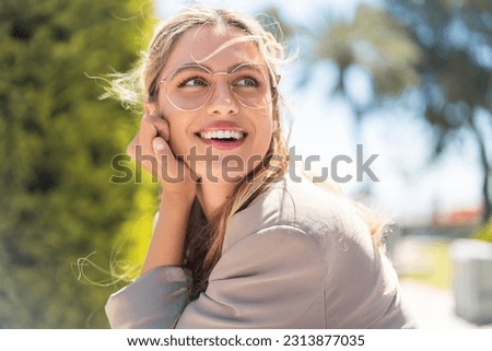 Pretty blonde Uruguayan woman with glasses at outdoors With happy expression Royalty-Free Stock Photo #2313877035