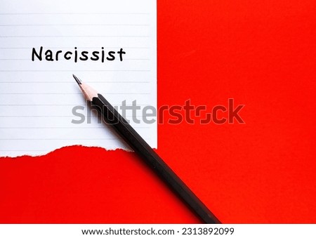 Torn paper on red copy space backgroundl with handwritten text NARCISSIST, self-centered inflated people of importance, need attention and admiration but lack empathy to others Royalty-Free Stock Photo #2313892099