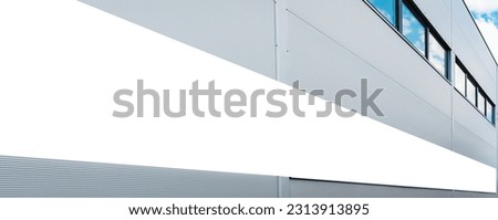 Mockup template.Big horizontal white blank advertising,billboard on modern business building wall outdoors.Banner,advertisement,panoramic view.