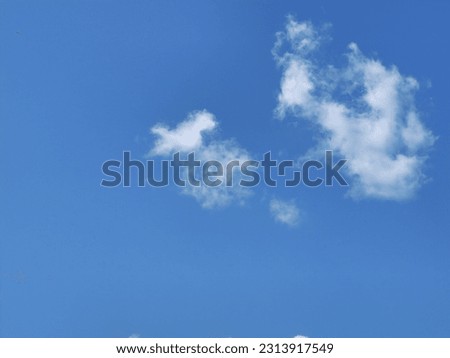 A solitary white cloud in the blue sky - a symbol of tranquility and the beauty of nature's stillness