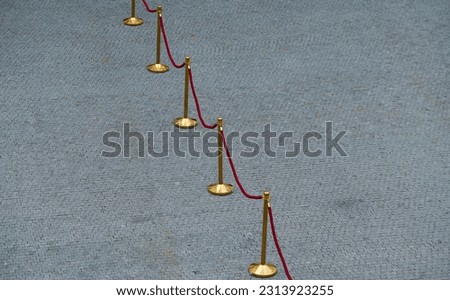 Boundary posts poles with red rope cord, photo with this protection fence used for events
