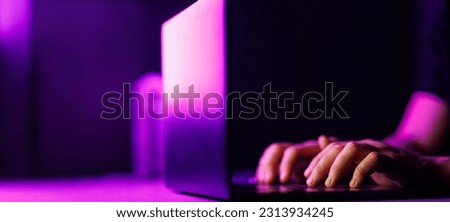 Man hands and Laptop on modern purple color environment. Copy space on black background. High quality photo