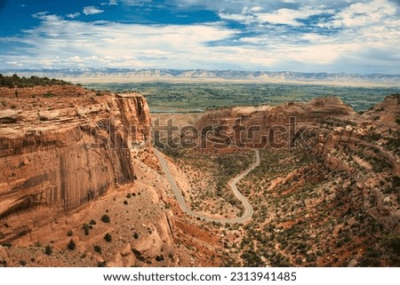 Colorado National Monument preserves one of the grand landscapes of the American West. curvy highway in the valley Royalty-Free Stock Photo #2313941485