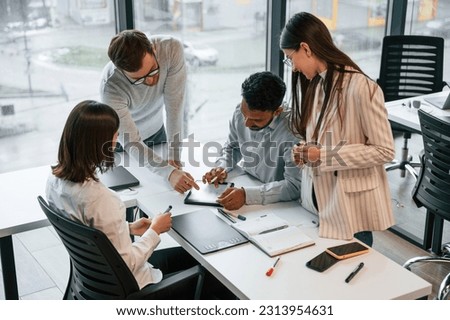 Conception of brainstorming. Four people are working in the office together. Royalty-Free Stock Photo #2313954631