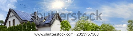 Solar panels on a gable roof. Beautiful, large modern house and solar energy. Rays of the sun. Space for text. Royalty-Free Stock Photo #2313957303