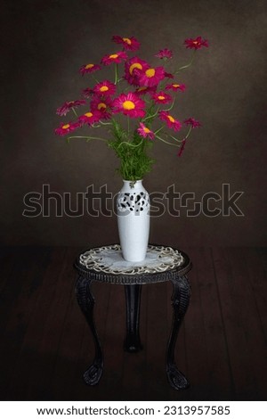 Still life with bouquet of red daisies on a dark background
