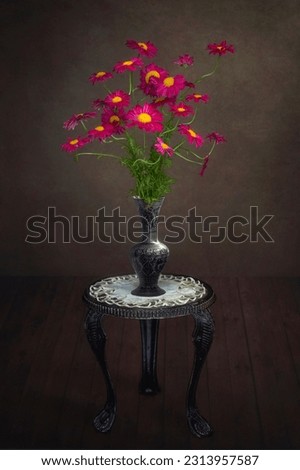 Still life with bouquet of red daisies on a dark background