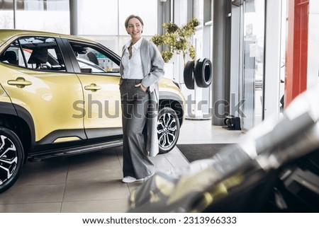 Business woman choosing a car in a car showroom
