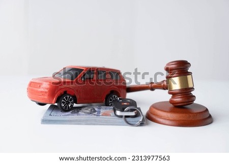 wooden hammers, toy cars, money and contracts, auction ideas and US dollar bills on car accidents, insurance claims lawsuits in court. Royalty-Free Stock Photo #2313977563