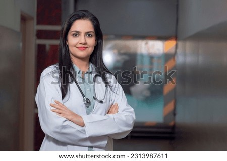 Medical concept, Indian female doctor in white coat with stethoscope standing at hospital. Royalty-Free Stock Photo #2313987611
