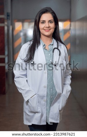 Medical concept, Indian doctor in uniform standing at hospital. Royalty-Free Stock Photo #2313987621