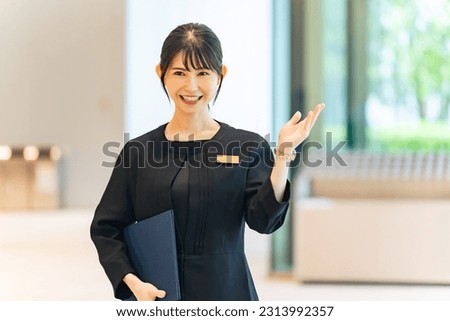 Asian female staff guiding in the lobby. Royalty-Free Stock Photo #2313992357
