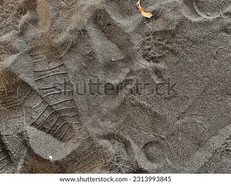 Footprints on the sand of Cangkring Beach, Yogyakarta