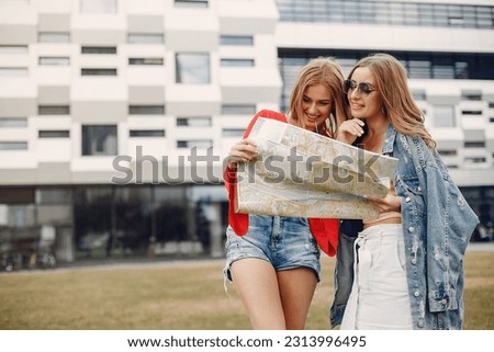 Elegant and stylish girls in a summer park