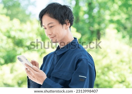 Asian man using a smart phone Royalty-Free Stock Photo #2313998407