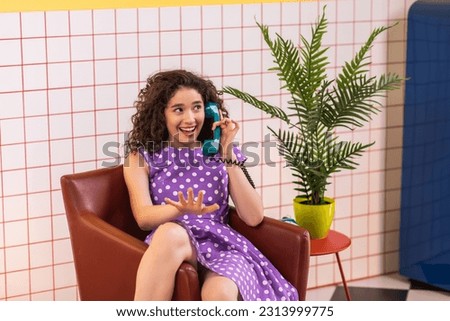 At home in the retro kitchen design happy and excited lady have a discussion on the landline phone they she start to smiling large Royalty-Free Stock Photo #2313999775