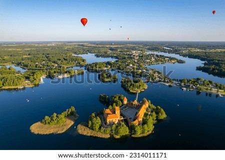 Aerial summer sunny sunset view of Trakai Island Castle and hot air balloons, Lithuania Royalty-Free Stock Photo #2314011171
