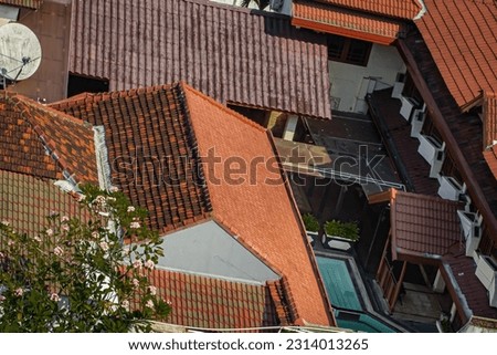 jojga, indonesia : 26 Mei 2023 : High angle view captures city rooftop graves, garden, trees, and building exterior.