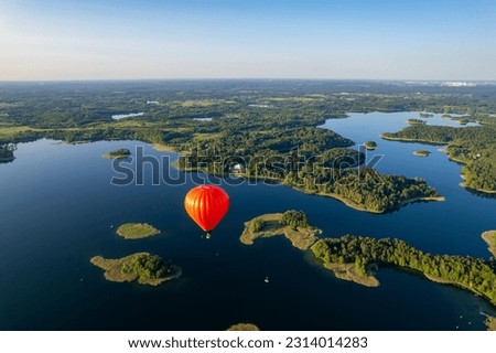 Aerial summer sunny sunset view of hot air balloon over Galve lake, Lithuania Royalty-Free Stock Photo #2314014283
