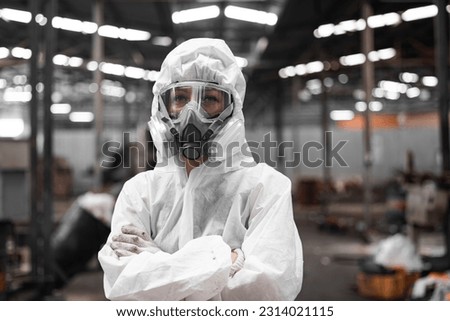 Industrial waste inspector wearing personal protective equipment to check hazardous chemicals, radioactive and toxic substances. Analyzing impact of factory's current projects, suggesting solutions. Royalty-Free Stock Photo #2314021115