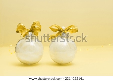 two white christmas balls. golden tie decoration with pearls. Horizontal composition for new year