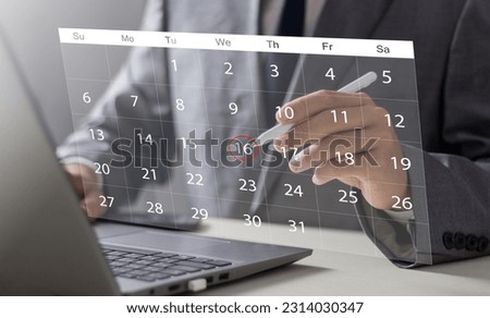 Businessperson or secretary manages time for effective work. Calendar on the virtual screen interface. Highlight appointment reminders and meeting agenda on the calendar. Time management concept.
