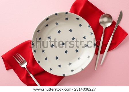 Create captivating display for your Independence Day event with table arrangement. Top view showcasing plate with star pattern, cutlery, red napkin. Add your own text or advert to complete the picture