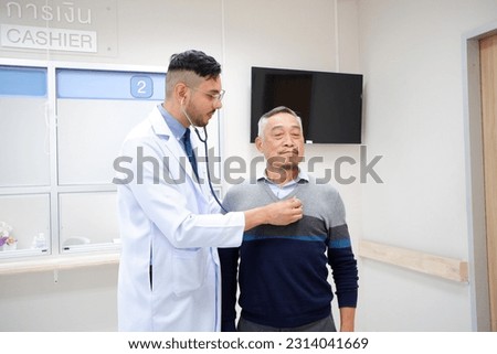 The doctor uses a medical stethoscope to listen to the heartbeat of an elderly patient.