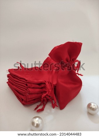 a pretty red pouch on a white beckground
