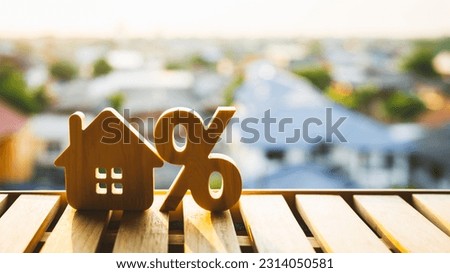 Silhouette of Percentage and house sign symbol icon wooden on wood table. Concepts of home interest, real estate, investing in inflation.