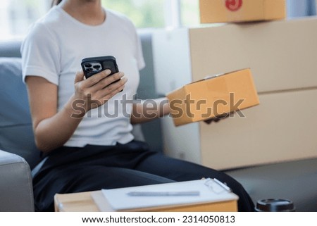 young woman small business owner Freelancer working from home checking balance online using smart phone. woman shopping online