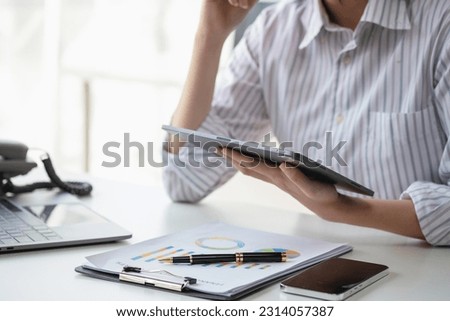 Financial advisor calculating numbers datasheets graphs charts reports marketing research development planning management strategy analysis financial accounting. Business office concept. Royalty-Free Stock Photo #2314057387