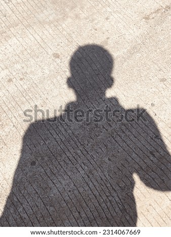 the shadow of a man on a hot day