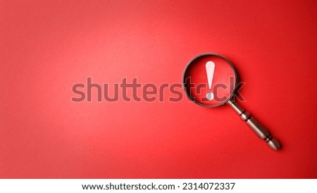 Magnifier magnifying exclamation mark on red background. Alert and precaution concept. Caution and risk management security signal announcement hazard and dangerous notice symbol Royalty-Free Stock Photo #2314072337