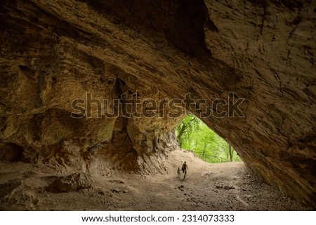 People visiting Istállós-kői Cave at Szalajka valley in summer - Mouth of a cave about 60 metres long and 17 metres high 