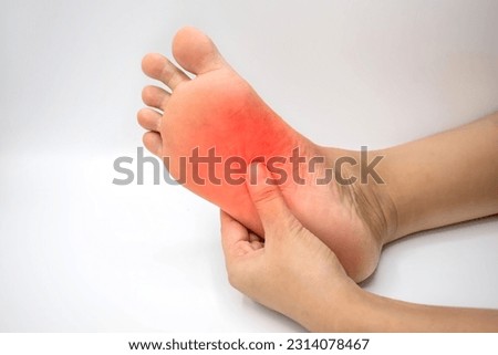 Inflammation at sole of Asian young woman. Concept of foot pain, plantar fasciitis, achilles tendonitis, etc. Royalty-Free Stock Photo #2314078467
