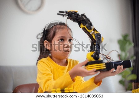 STEM education concept. Asian students learn at home by coding robot arms in STEM, mathematics engineering science technology computer code in robotics for kids' concepts. Royalty-Free Stock Photo #2314085053
