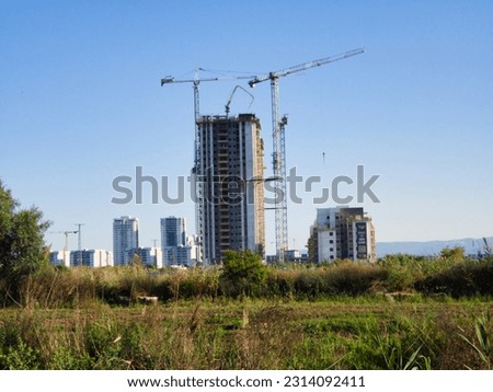 a beautiful photo of a construction site seen from the local nature reserve
