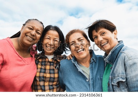 Happy multiracial senior women having fun smiling into the camera at house rooftop Royalty-Free Stock Photo #2314106361