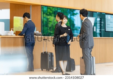An usher woman serving tourists at the front desk. Hotelier. Royalty-Free Stock Photo #2314108027