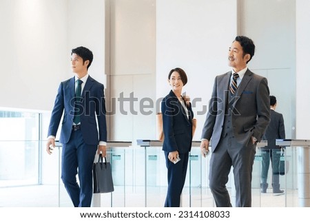 Group of business people walking in office building lobby. Royalty-Free Stock Photo #2314108033
