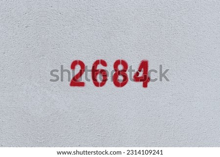 Red Number 2684 on the white wall. Spray paint.
