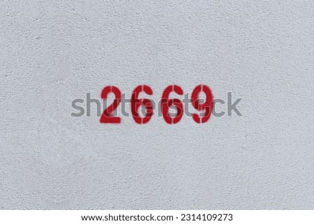 Red Number 2669 on the white wall. Spray paint.
