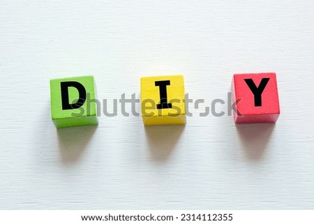 DIY letter on wooden block; Do It yourself concept Royalty-Free Stock Photo #2314112355