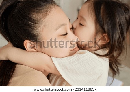 Little girl kissing her mom