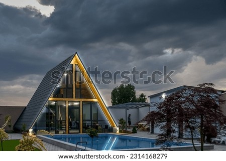 modern triangular wooden eco-house with a pool
 Royalty-Free Stock Photo #2314168279