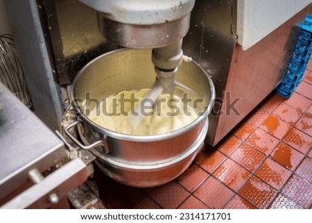 A close-up shot of dough making process in a planetary mixer Royalty-Free Stock Photo #2314171701