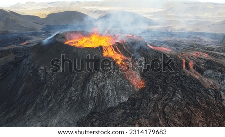 A landscape of lightening erupting from Mauna Loa Volcano in Hawaii with smoke and a hazy sky Royalty-Free Stock Photo #2314179683