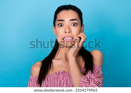 Photo of young nervous girl panic biting her nails hand crazy staring scared high prices no discount isolated on blue color background