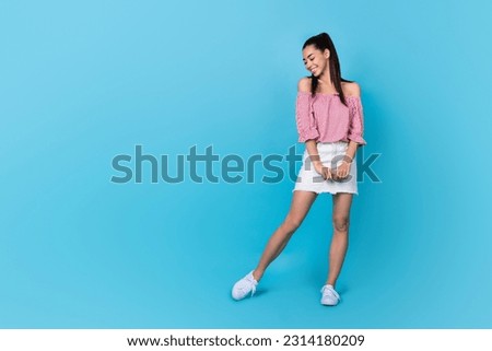 Full length photo of lady wear mini skirt red blouse posing slim fit looking preppy kind candid person isolated on blue color background
